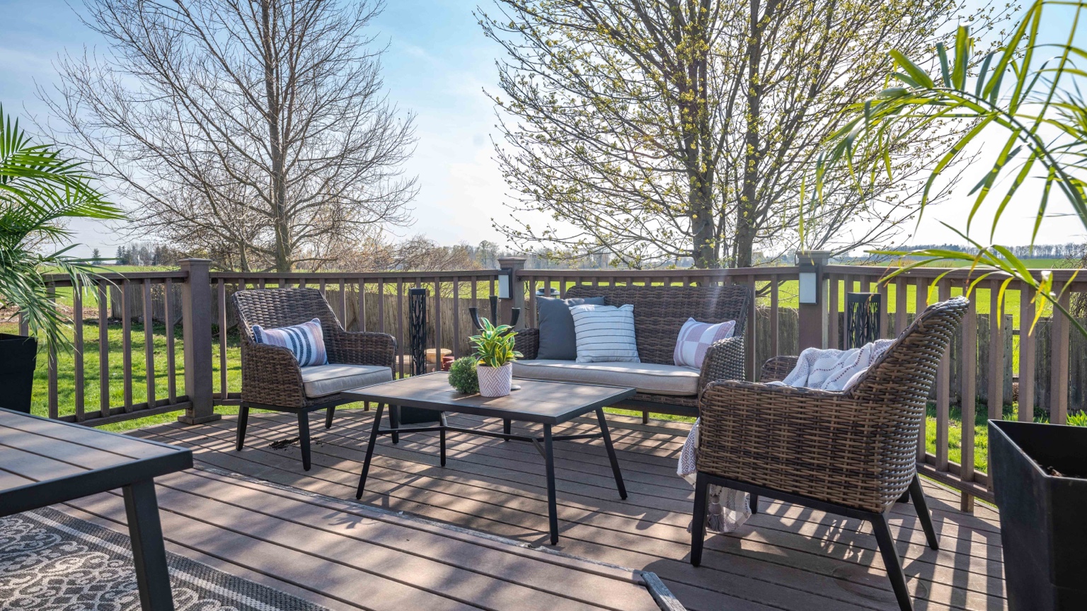 Finished outdoor deck with seating overlooking green landscape