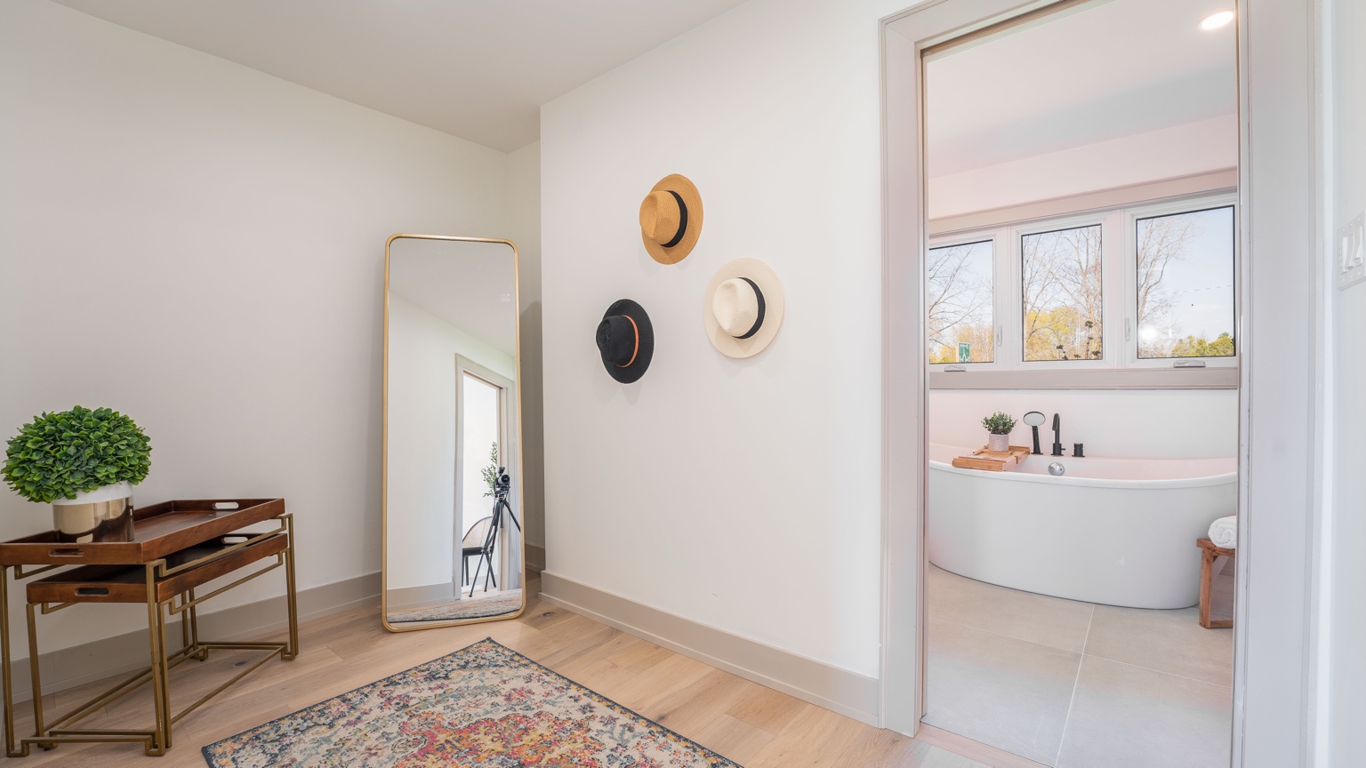 Finished dressing area leading into a bright bathroom